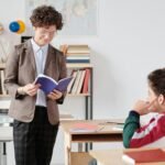 Teacher reading to students in a bright classroom setting, fostering an engaging learning environment.